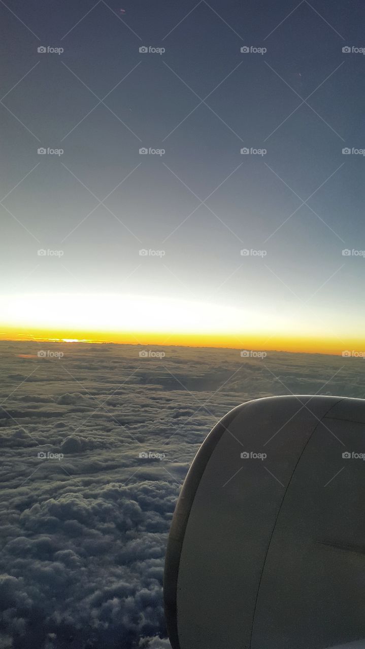 flying at sunrise. wings plane under clouds at sunrise