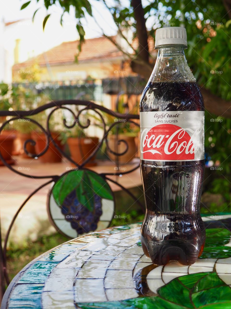 Diet Coke bottle on garden table.