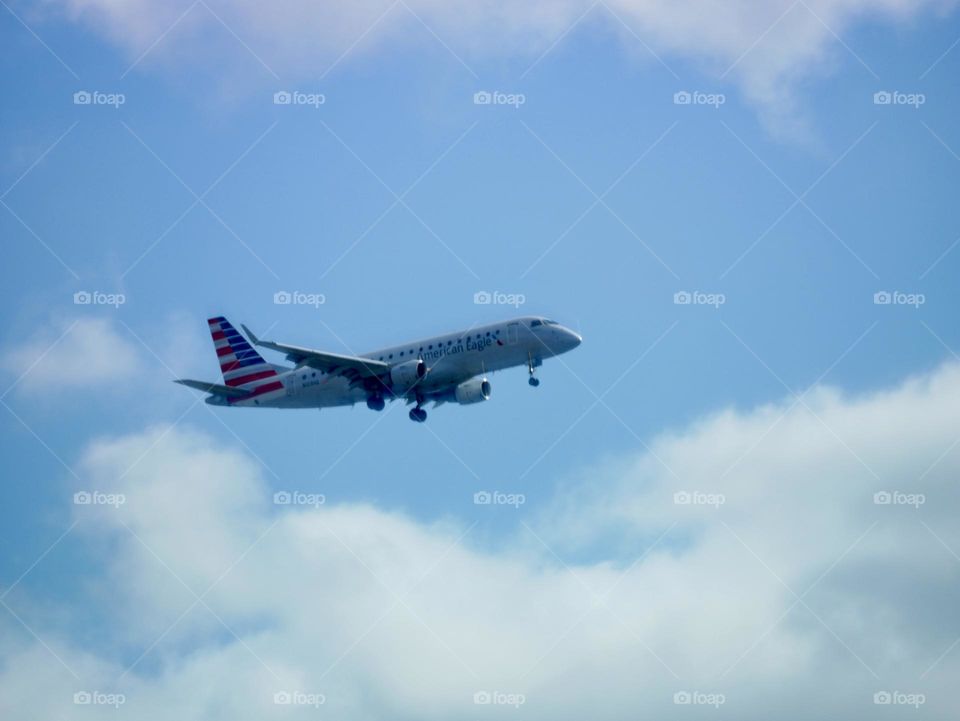 An American Eagle airplane comes in for a landing, near the local airport. 