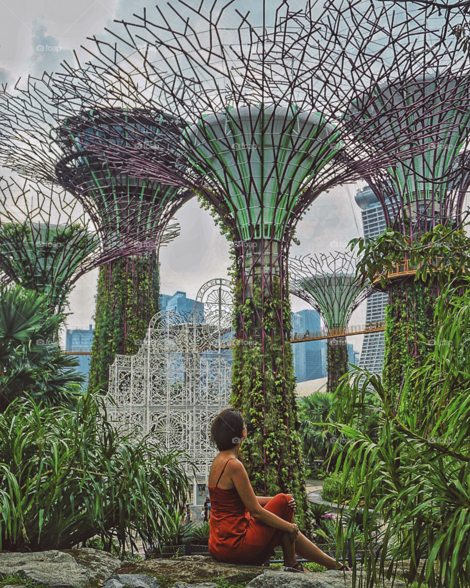 Girl sitting against the Gardens by the Bay in Singapore