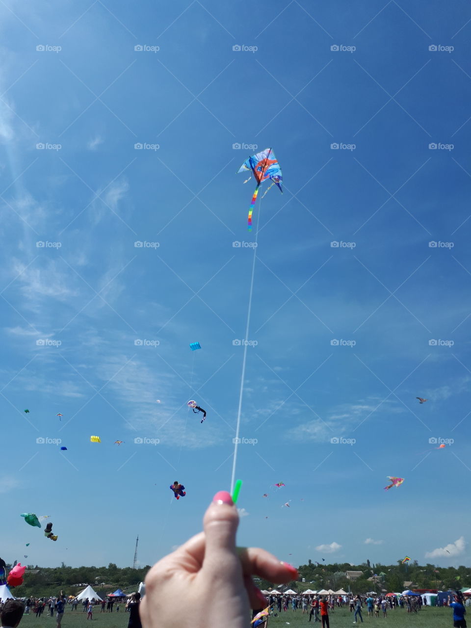 Girl riding a kite. Kite show.  Kite in the sky