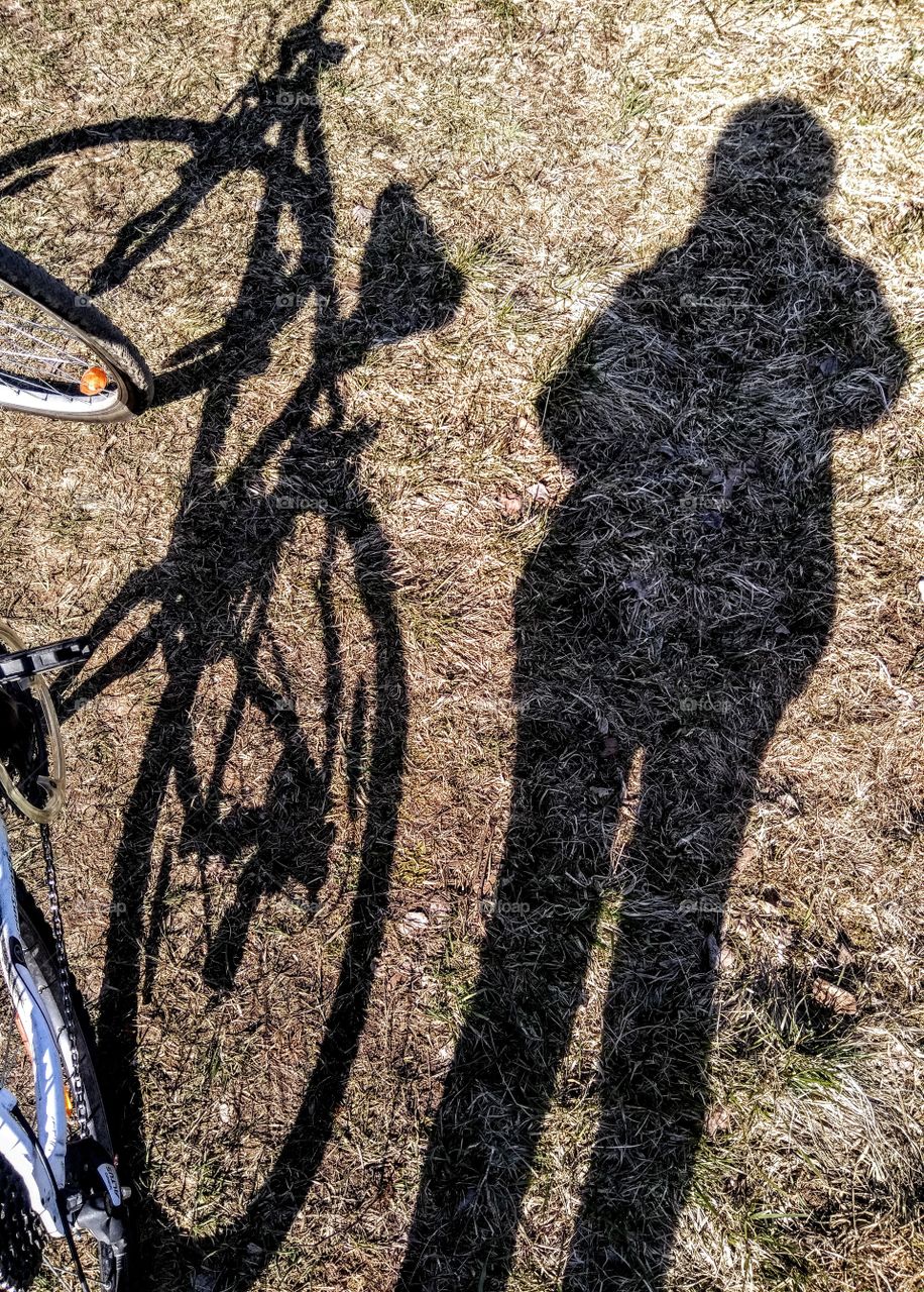 shadow person and bike in nature spring  time isolation social distance