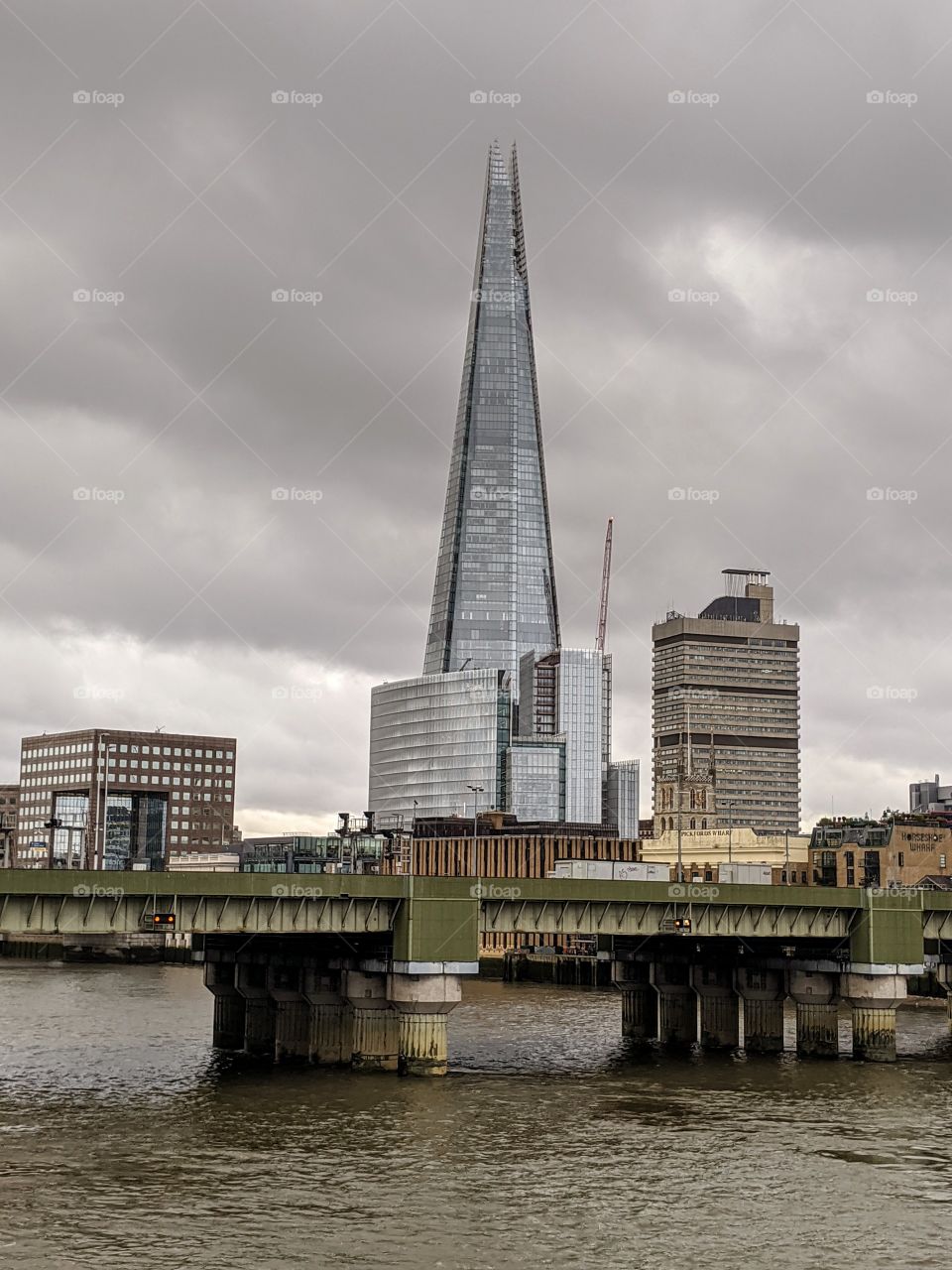 walking across the Thames; bridge view; architecture; cloudy day; London experience