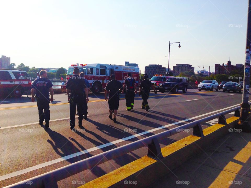 Firefighters in action. Firefighters in action on the bridge of Boston on Sunset