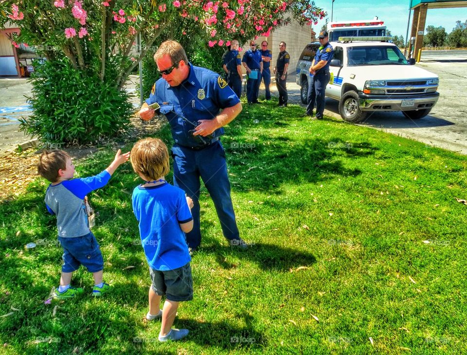 Firefighters with admiring children