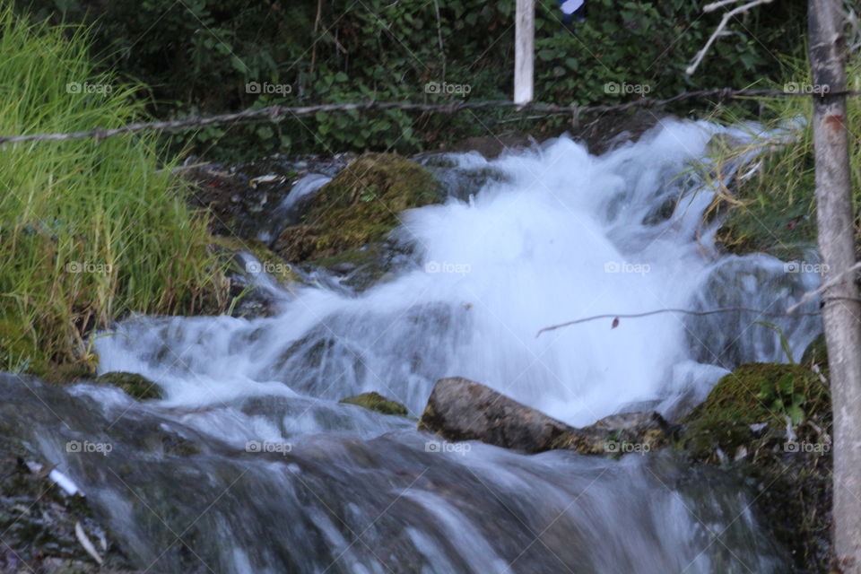 water stream flowing through mountain