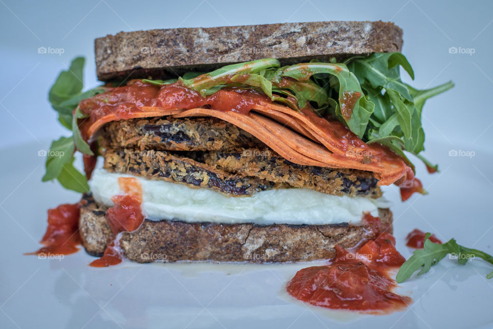 Yummy eggplant Parmesan sandwich loaded with mozzarella and pepperoni 