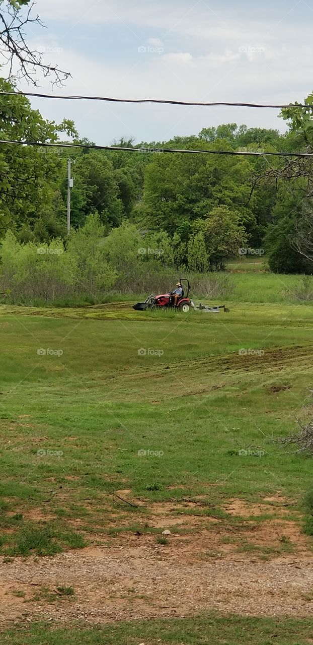 man on tractor in county