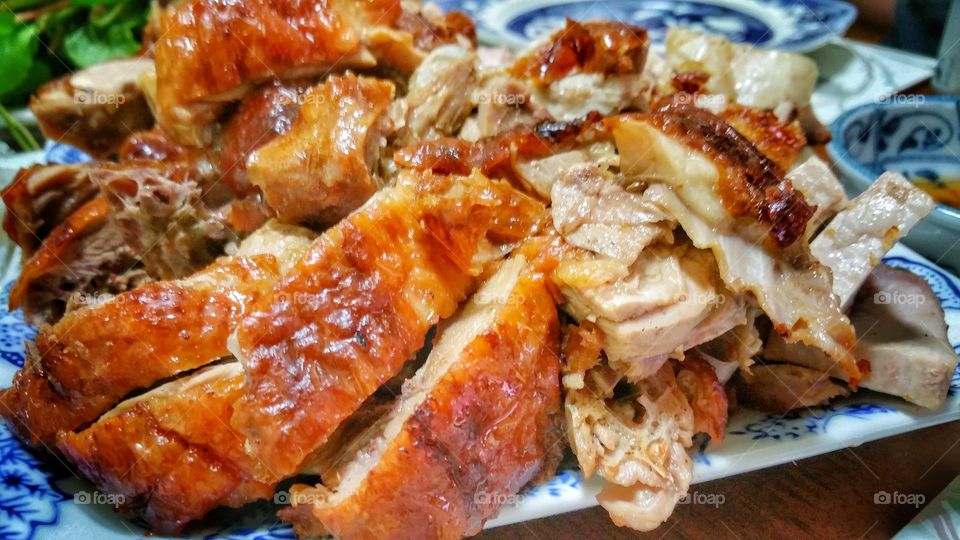 Cantonese roast duck, presented on a plate in bite-size pieces. The duck has a shinning red-brownish skin and is frequently seen hanging behind shop windows.