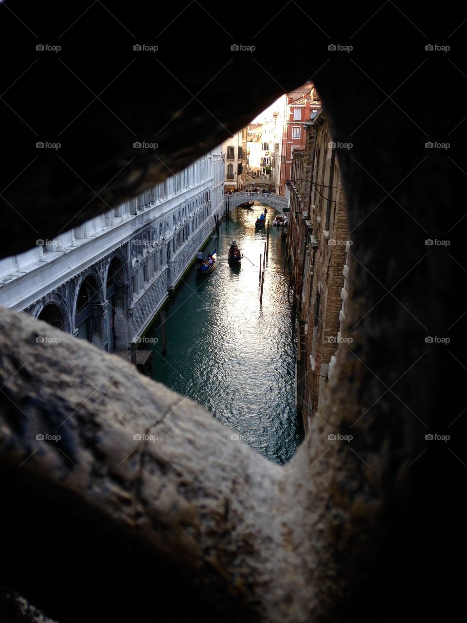 Peephole . A shot through the bridge in Venice, Italy 