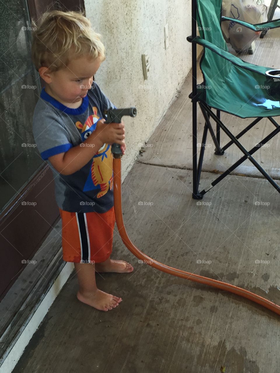 Toddler with a water hose