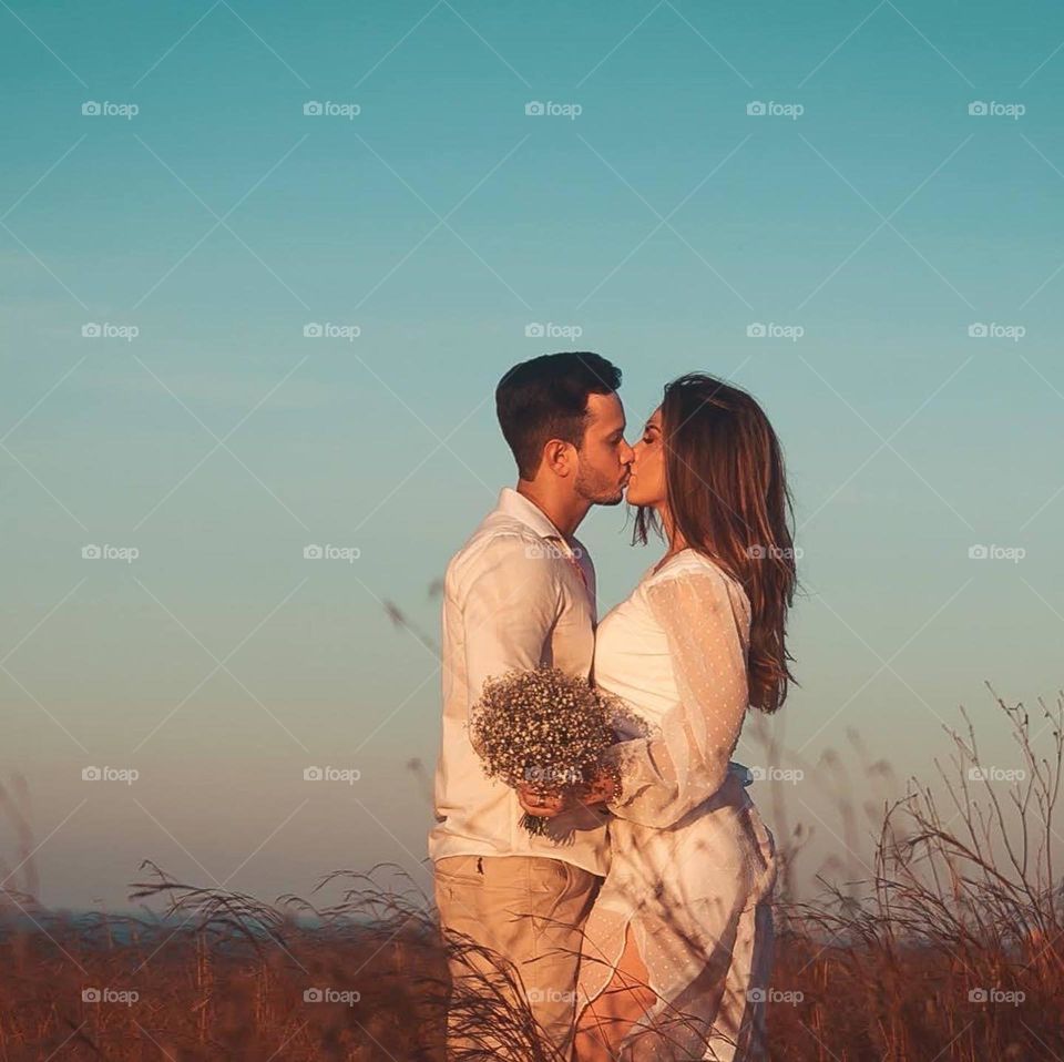 Loving couple kissing in the field