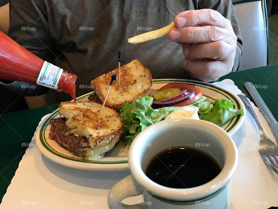 Man with patty melt sandwich