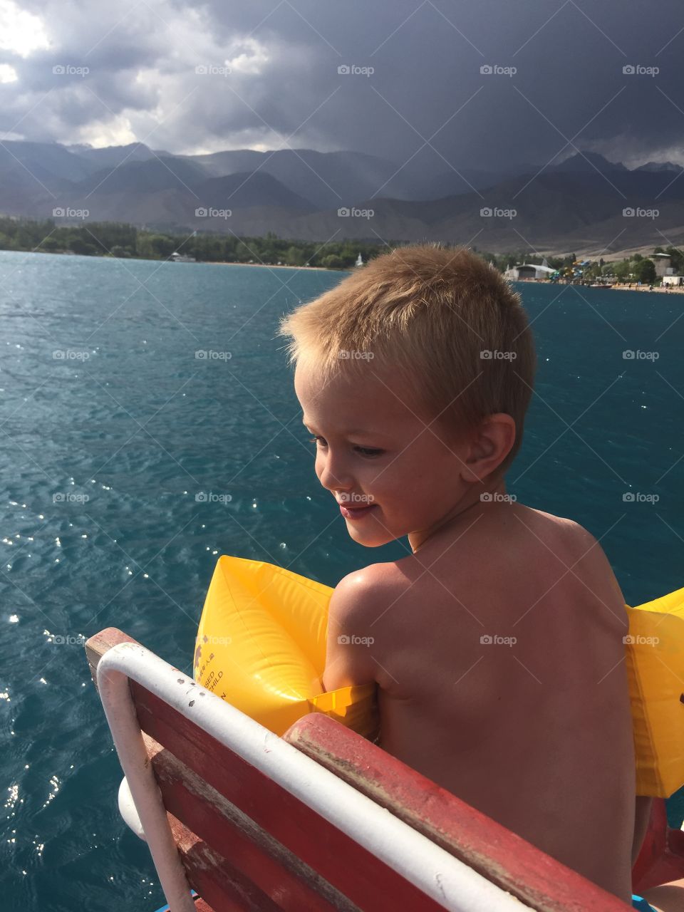 A child at sea hours before a thunderstorm