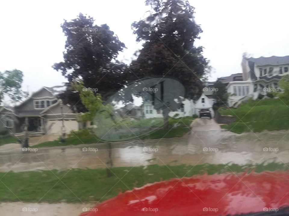 Two homes rain trees road red truck