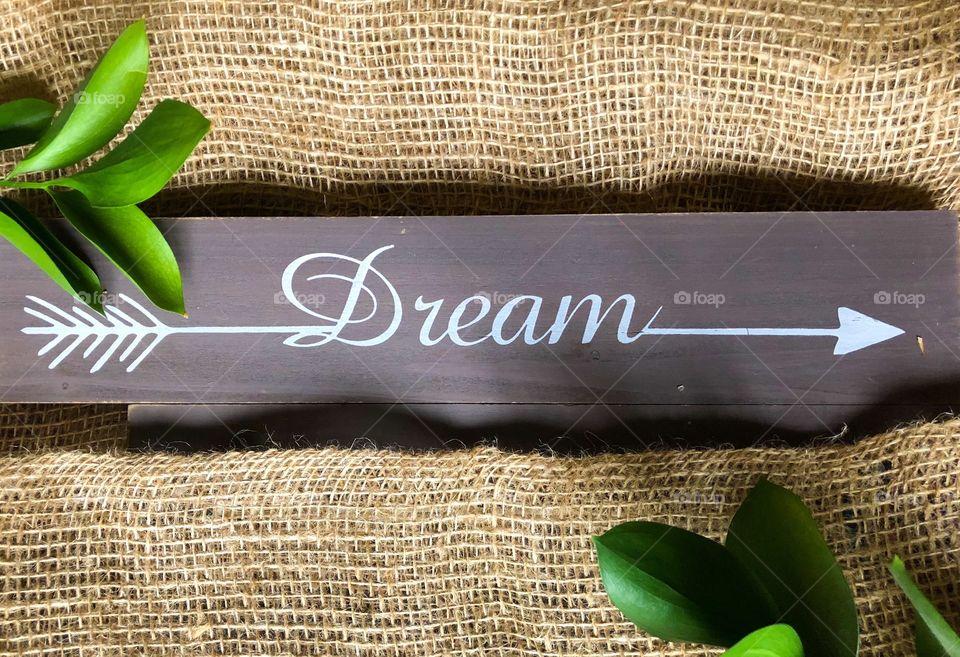 inscription dream on wooden and canvas background