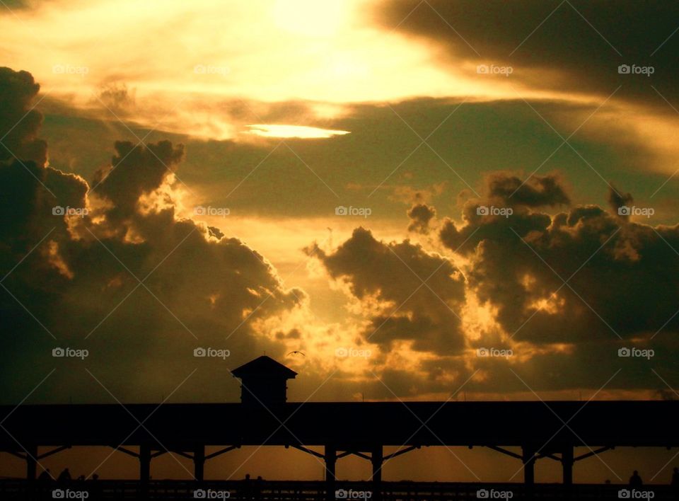 Pier over the ocean at sunset