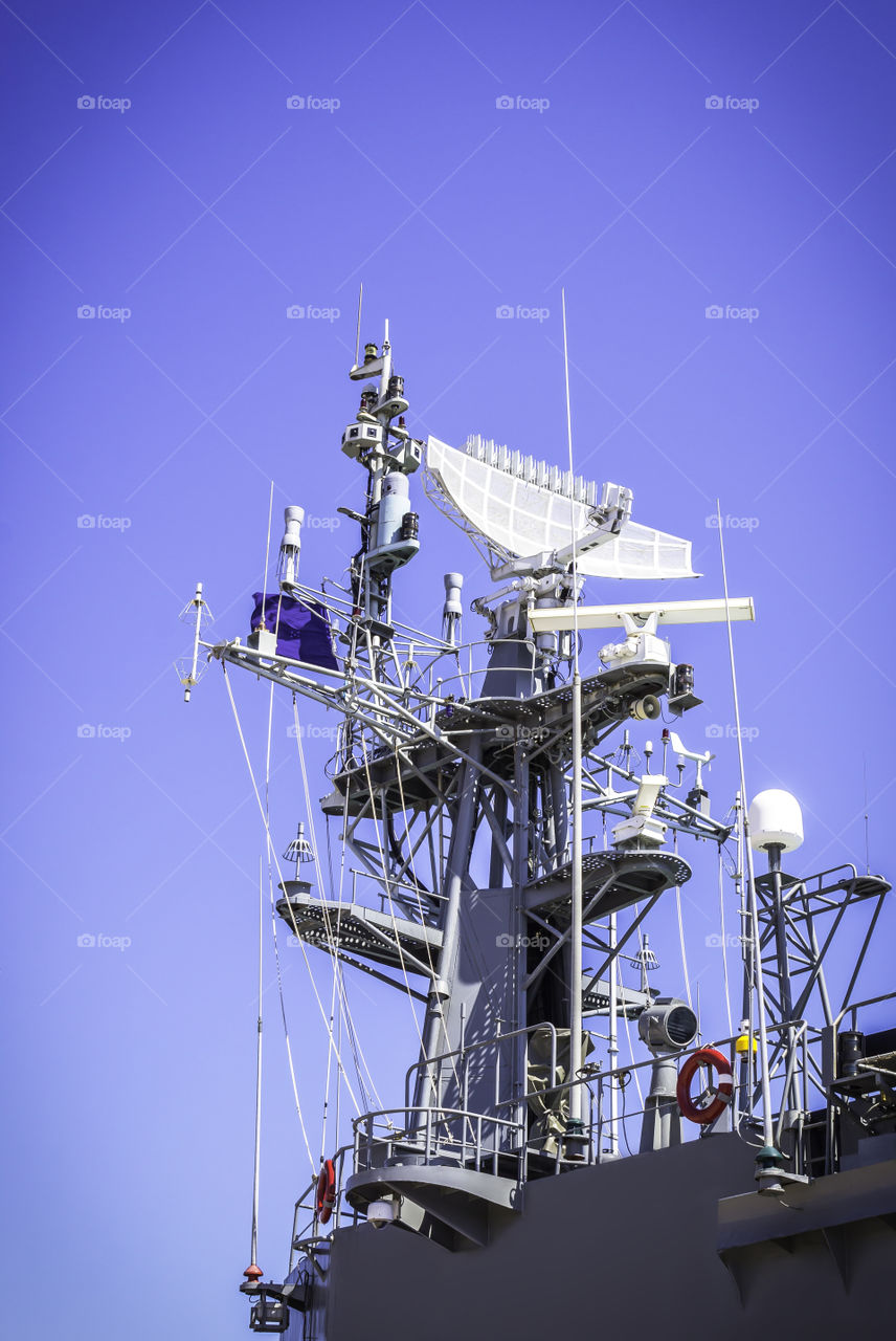 Radar on battleship with blue sky background