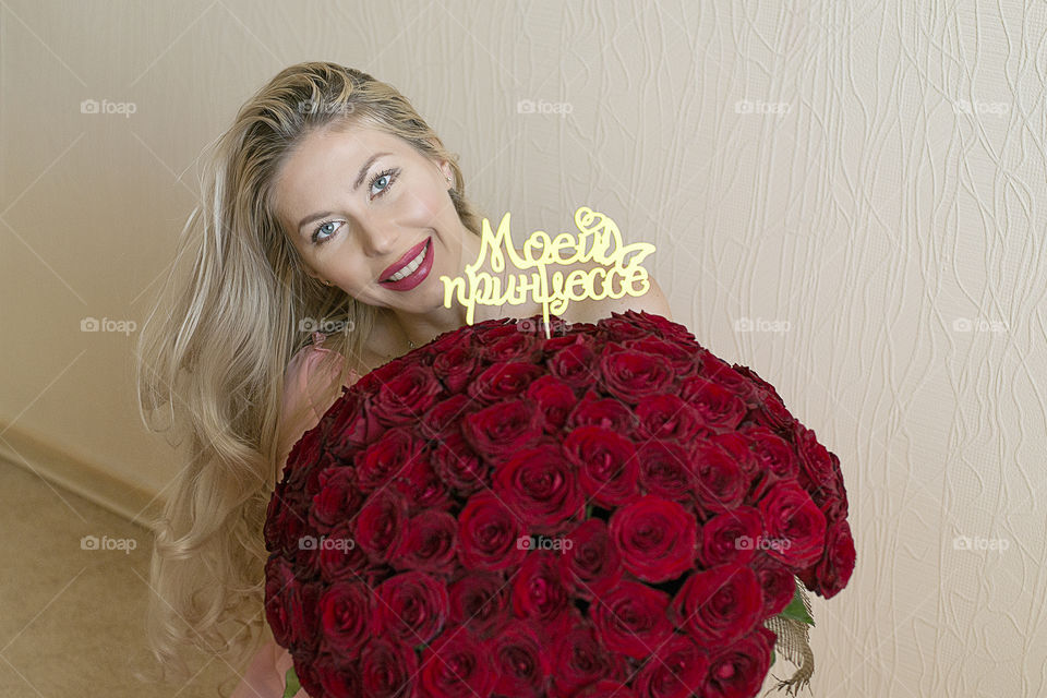 girl with a large bouquet of roses