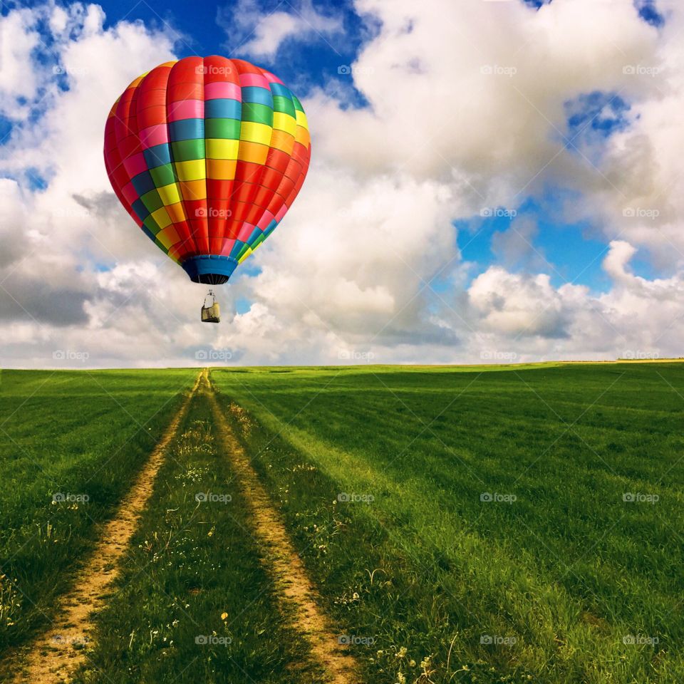 Hot air balloon against grass field