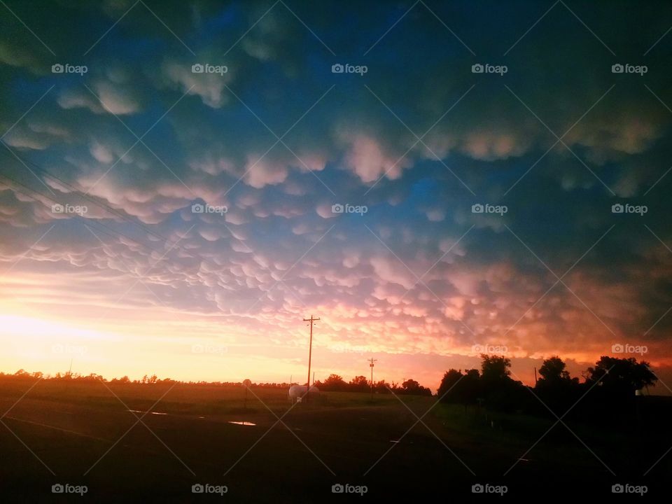 Colorful mammatus clouds over Nebraska at sunset. These clouds were on the back of a severe thunderstorm.