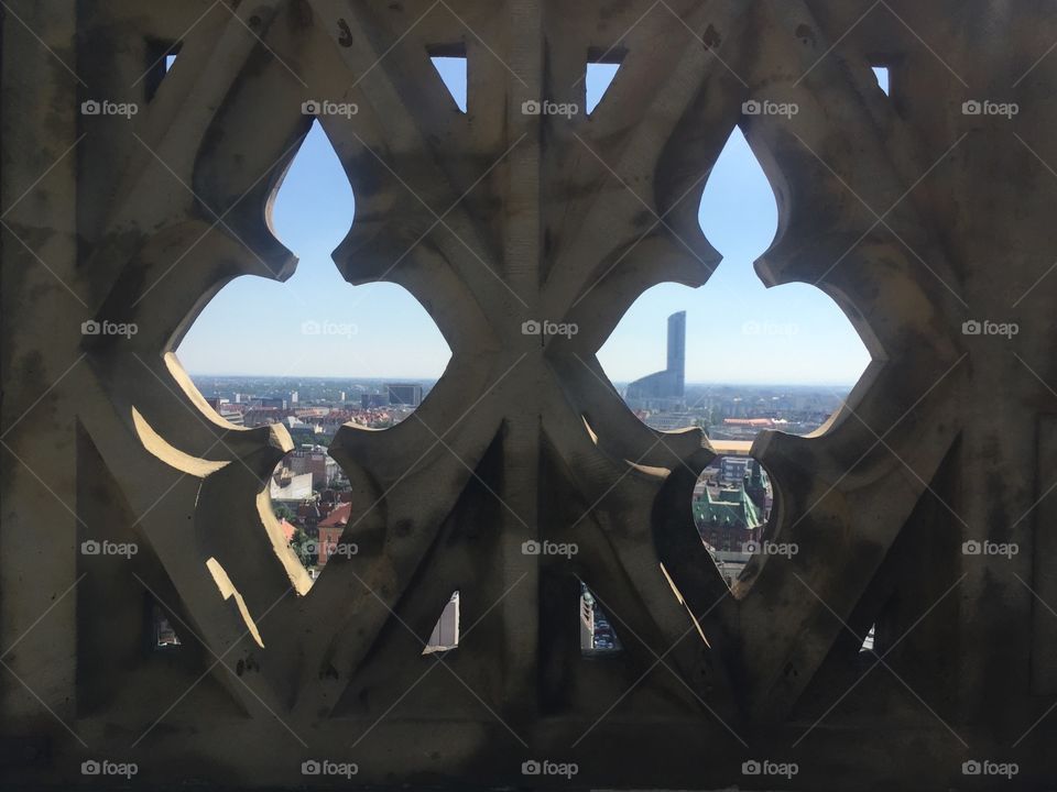 Cityscape through the fence holes