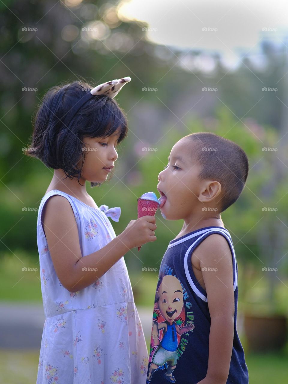 The children enjoy their ice cream during summer time.