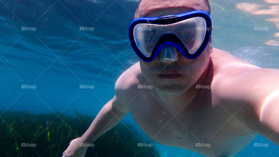 young man underwater diving