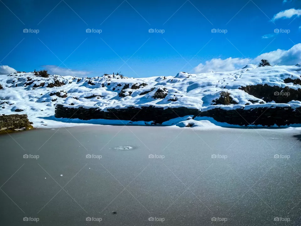 a pond on the snowy mountains.