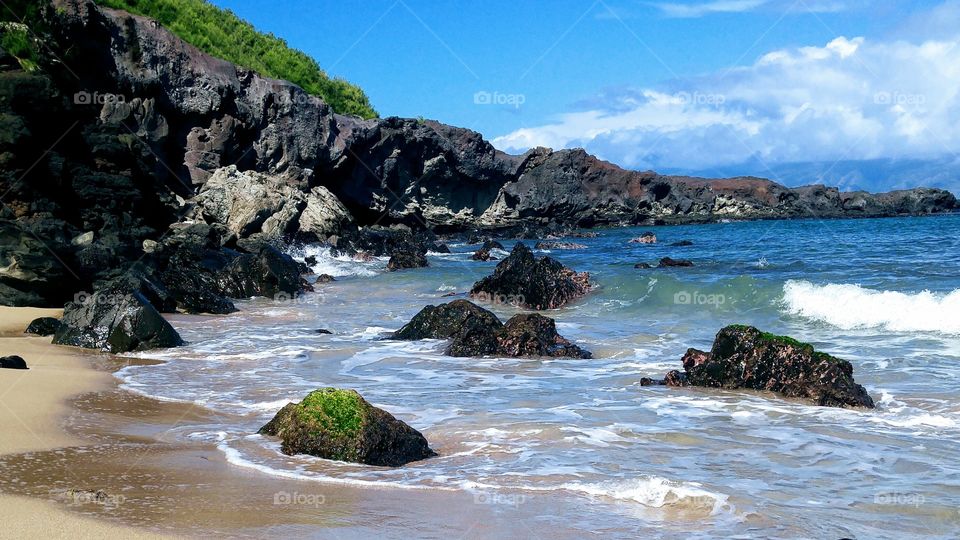 a seashore with lava rocks