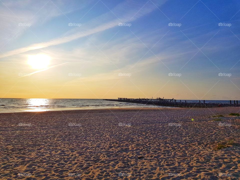 Sun is getting down in a beautifull beach.