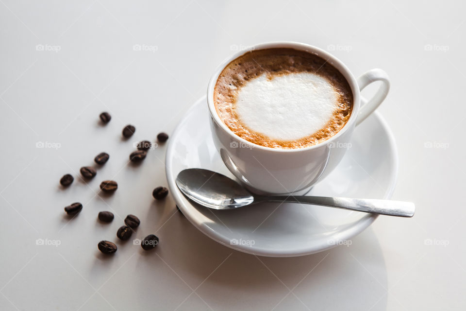 cup of coffee with coffee beans