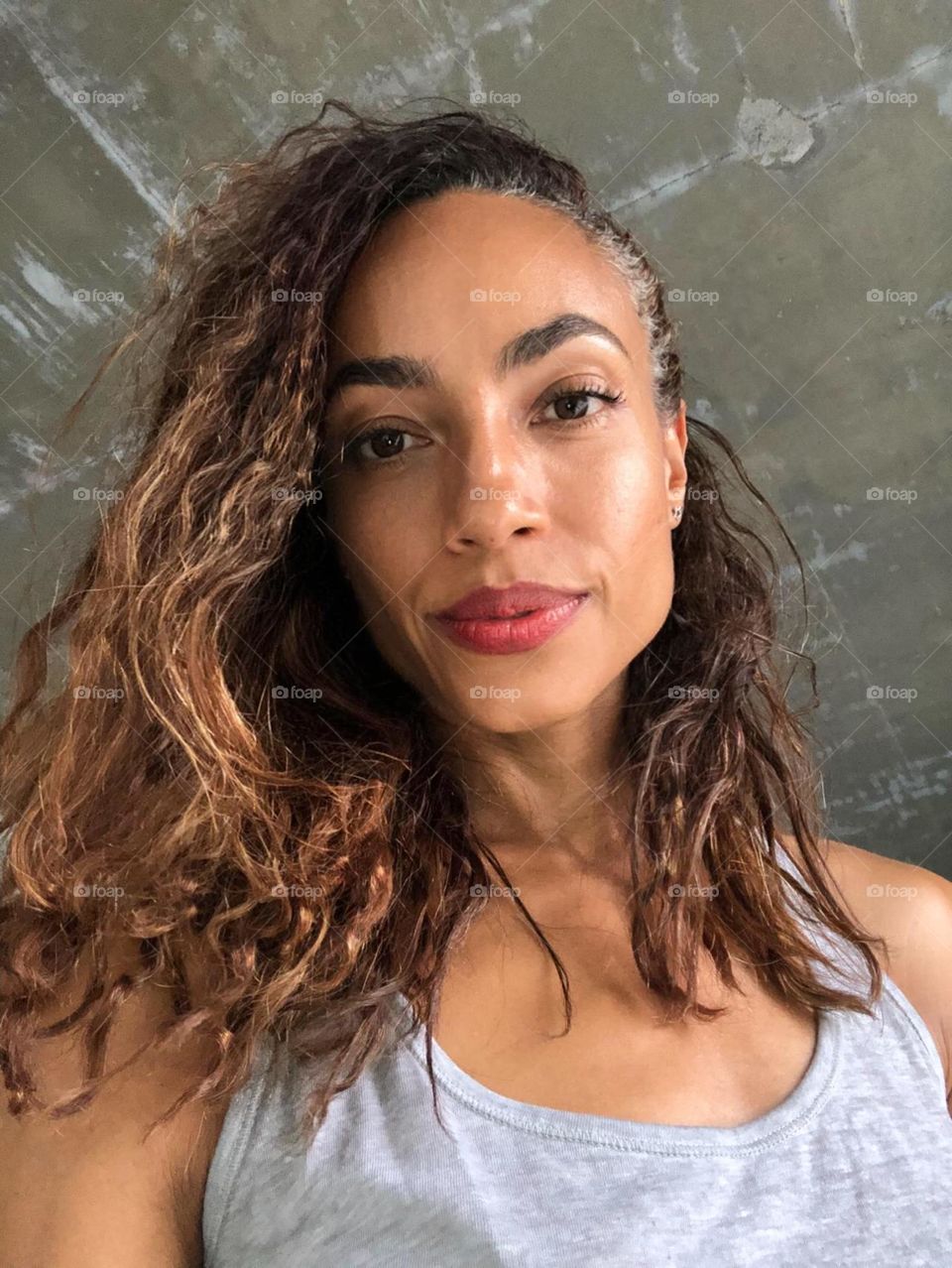 An exotic woman looks into the camera with a soft smile