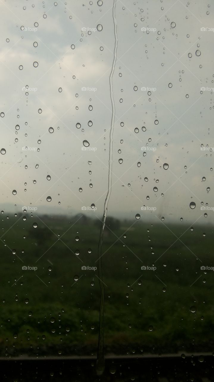 rain drops on a glass window on a rainy day.