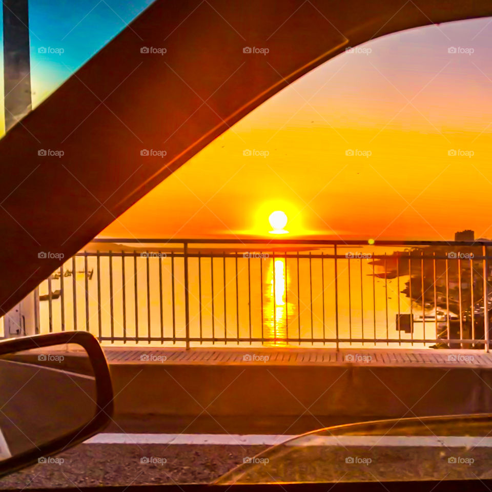 Horrific sunset over the mouth of the River Douro viewed from a car window on a bridge