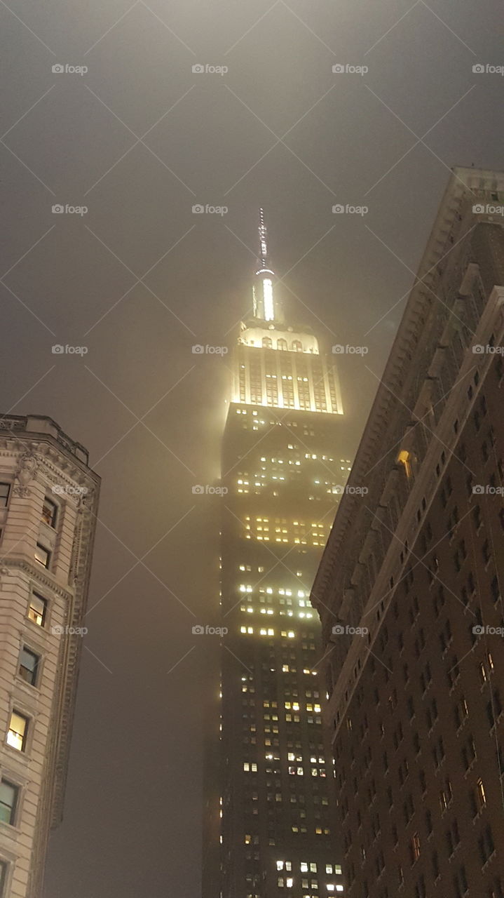 The Empire State Building on a foggy New York evening