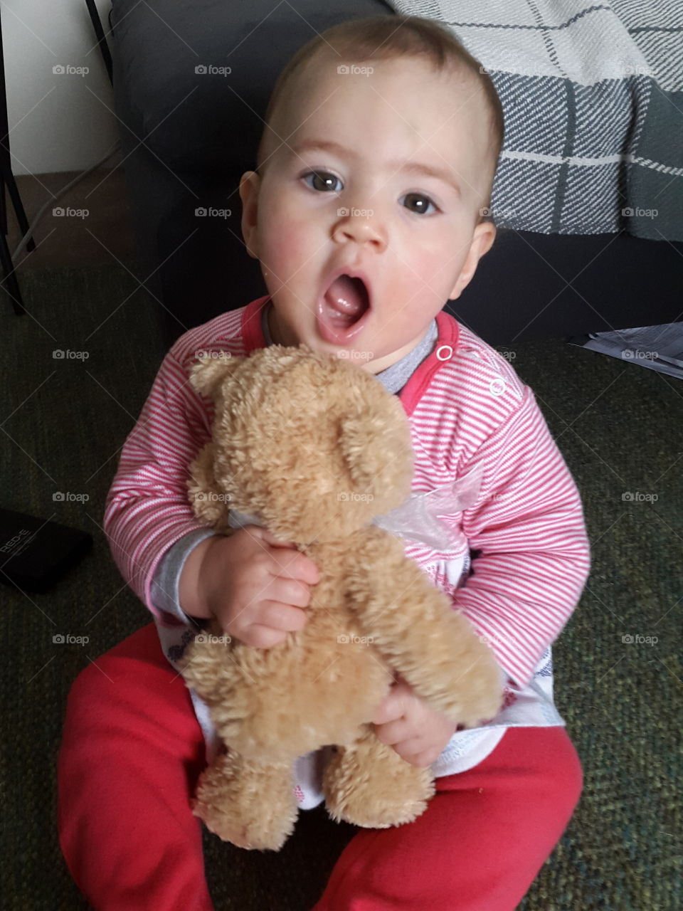 Cute baby boy yawning while sitting