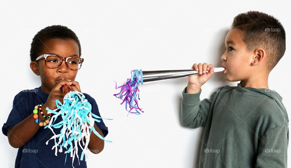 Boys Blowing Party Horns 