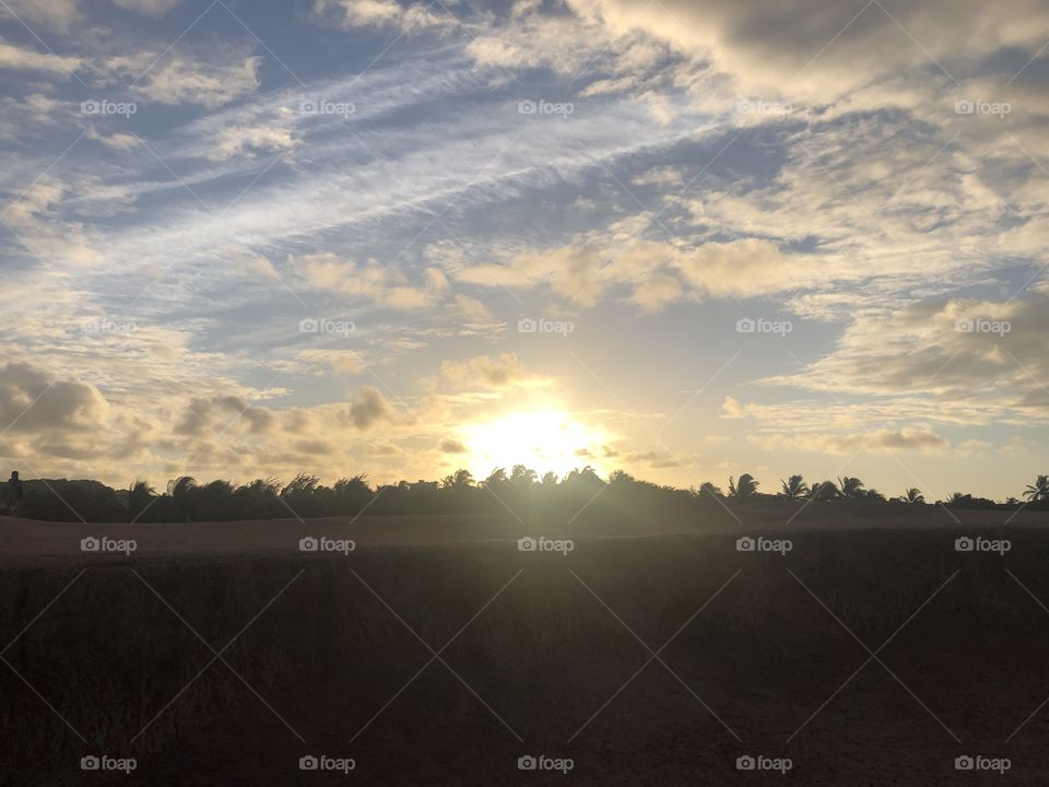 Sunset in a cloudy sky in tropical coastline