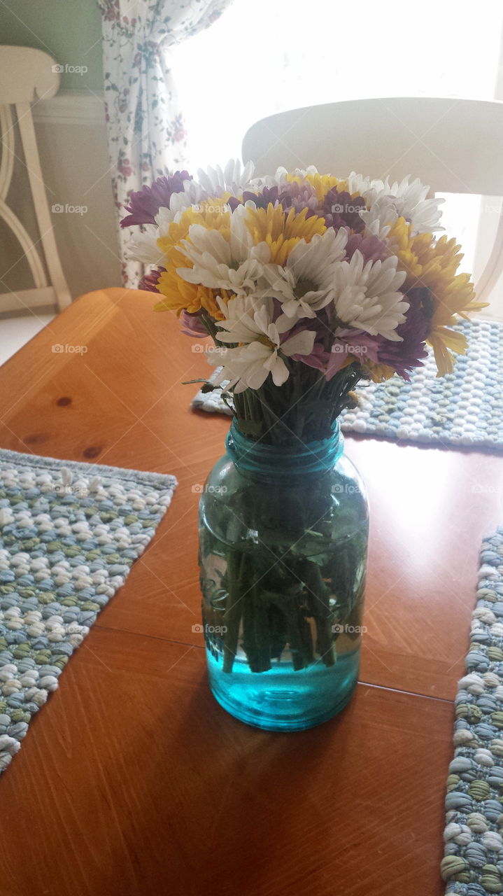 Jar of daisies. old mason jar filled with fresh cut field daisies