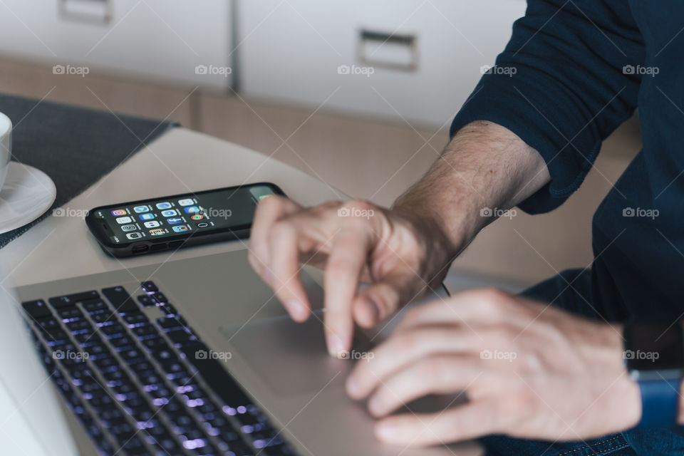 The man is using a laptop