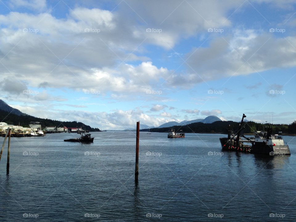 World famous Time Bandit crab boat from TV show Deadliest Catch anchored in Tongass Narrows during salmon fishing season. Another tender anchored as well, and seine fishing boat passing through after getting fuel 