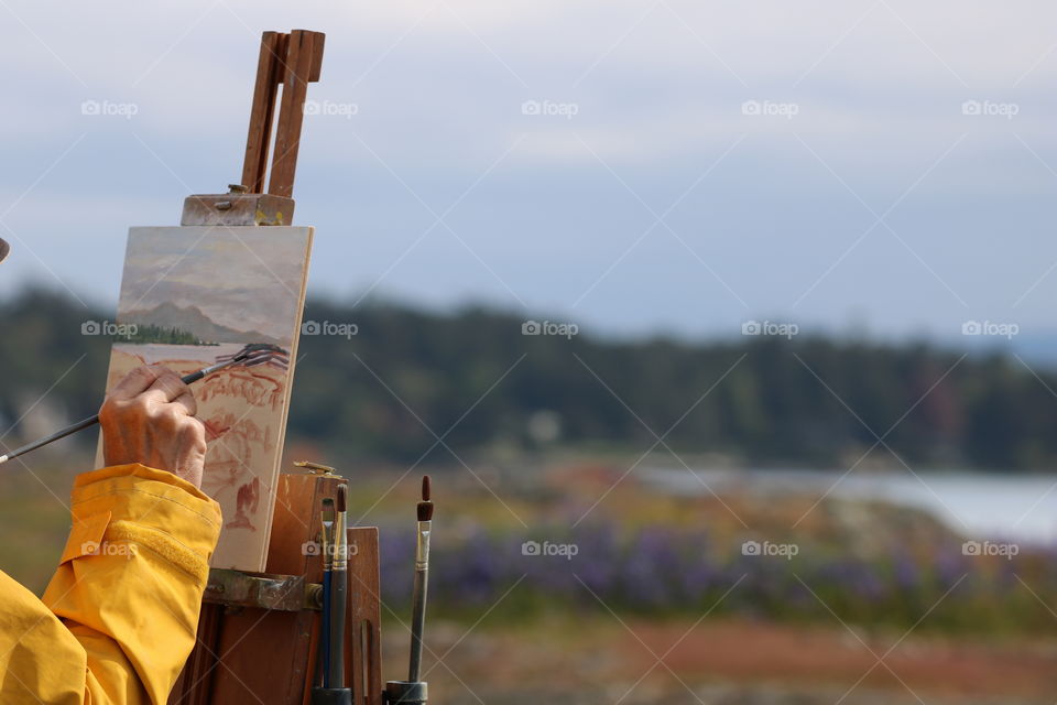 Painter’s hand making beautiful art in the nature 