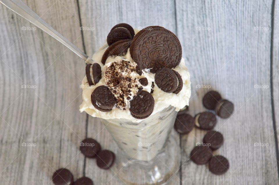 Oreo cookie milkshake with a wooden rustic white background