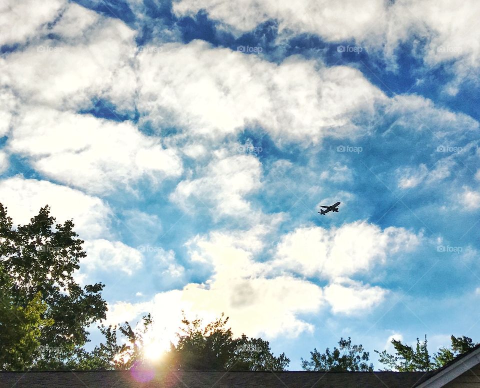 Cloud sky over house and trees