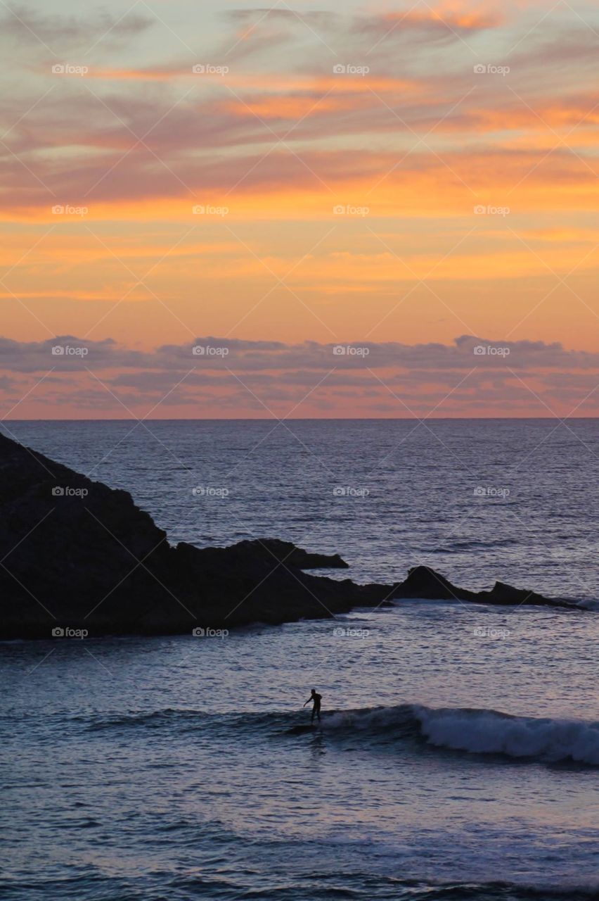 Surfer chilling at sunrise