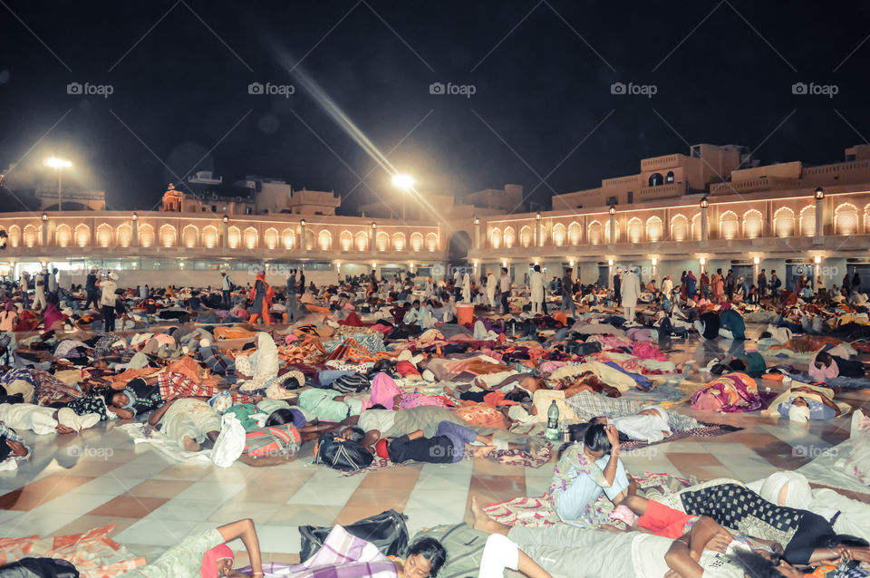 Amritsar, India - MAY 16 2016: People sleeping on the floor of of the Sikh Golden Temple in Amritsar, India.