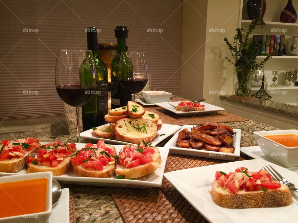 Homemade starters... Organic Tomato Roasted Peppers Soup, Baked Plantain Bananas, Garlic Bread, Bruschetta & paired with a glass of  Red Blend.