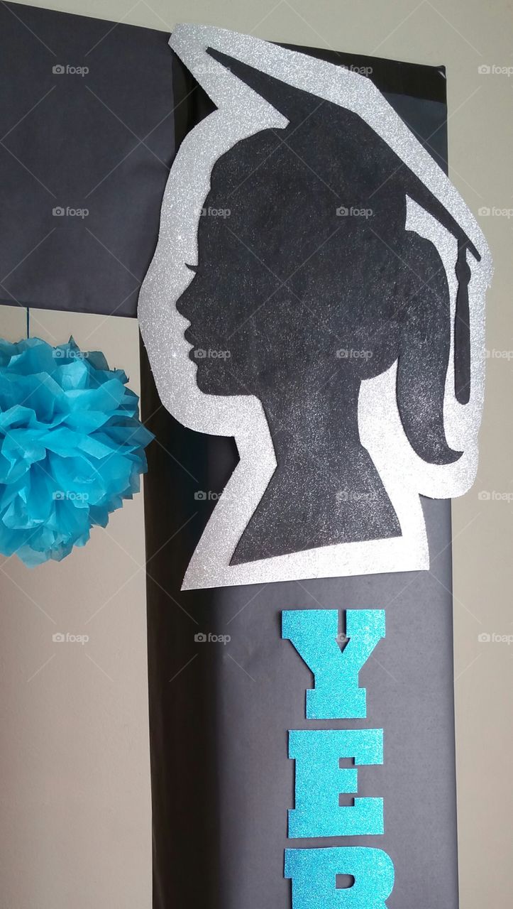 Grad girl silhouette with turquoise pom pom