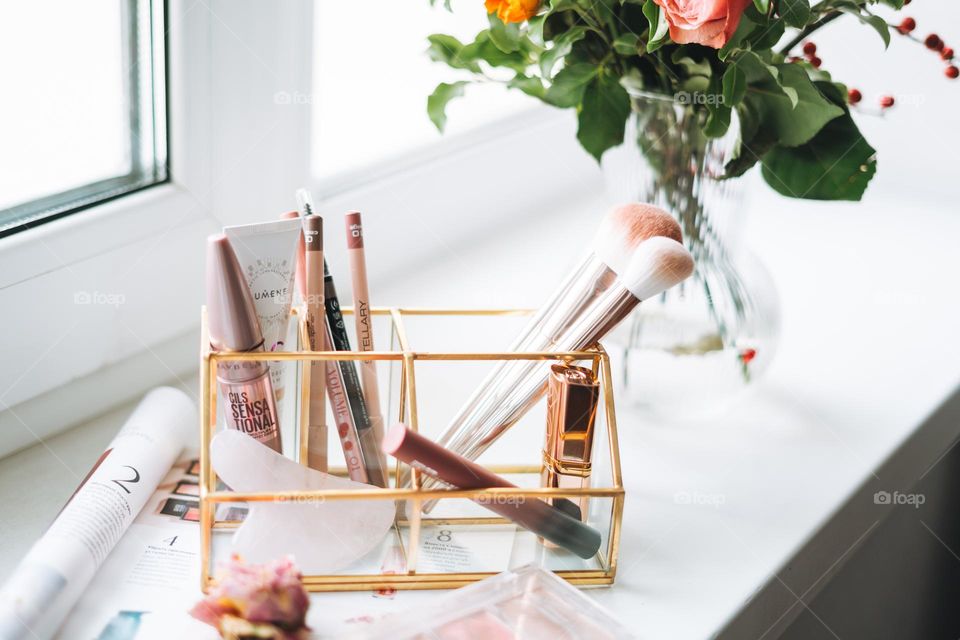 Makeup products on window sill